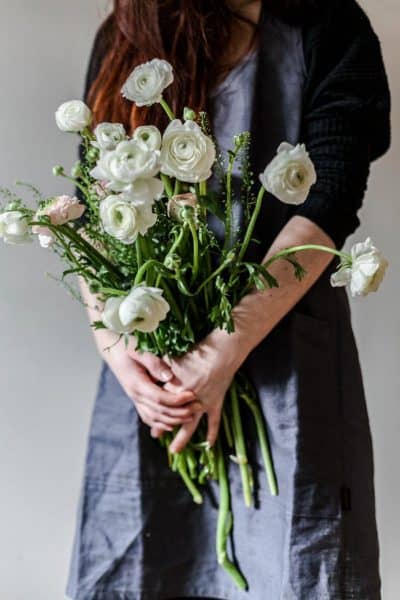 image of woman holding roses indoors how to care for roses indoors