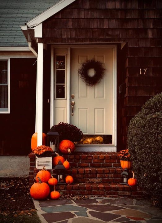 image of fall decorated front door with a wreath