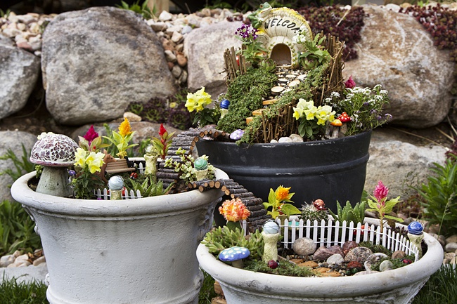 image of kids fairy garden in pots on patio